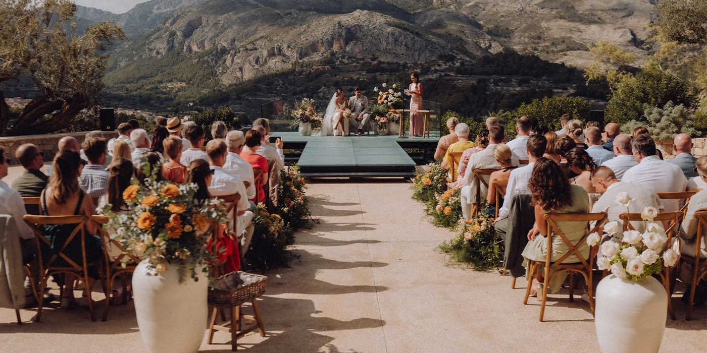 Ceremonia de boda íntima en la naturaleza con invitados y altar decorado en un entorno montañoso en nuestro hotel VIVOOD Alicante
